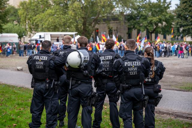 12 September 2026, North Rhine-Westphalia, Bielefeld: Police officers stand on the sidelines of a demonstration titled "Project M1llion Berlin, Unity for Germany, Resignation of the Current Federal Government + Friedrich Merz." Photo: Christian Knieps/dpa