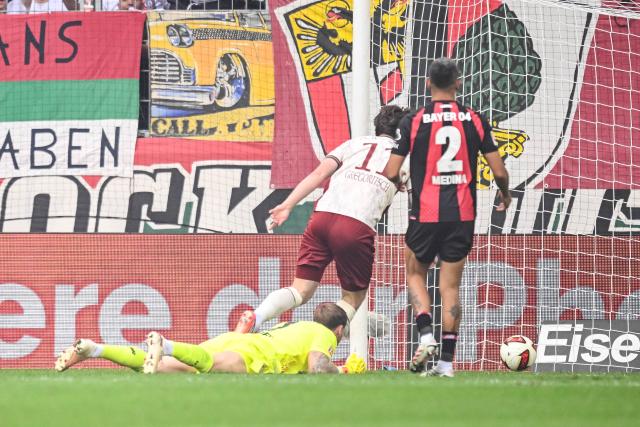 12 September 2026, Bavaria, Augsburg: FC Augsburg's Michael Gregoritsch (L)  scores his side's first goal during the German Bundesliga soccer match between FC Augsburg and Bayer Leverkusen at WWK-Arena. Photo: Harry Langer/dpa - WICHTIGER HINWEIS: Gemäß den Vorgaben der Bundesliga bzw. des DFB Deutscher Fußball-Bund ist es untersagt, in dem Stadion und/oder vom Spiel angefertigte Fotoaufnahmen in Form von Sequenzbildern und/oder videoähnlichen Fotostrecken zu verwerten bzw. verwerten zu lassen.