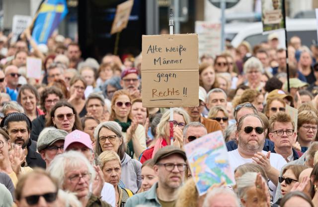 12 September 2026, Hamburg: A woman holds a banner reading "Old white men against the right!" during the coalition demonstration against right-wing extremism and for democratic cohesion following the state election in Saxony-Anhalt. Photo: Georg Wendt/dpa