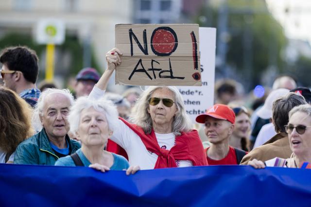 12 September 2026, Berlin: A participant holds a sign that reads "No AfD!" during a march in support of social cohesion from Unter den Linden to the Rotes Rathaus-one under the slogan "Time for a Change". Photo: Christoph Soeder/dpa