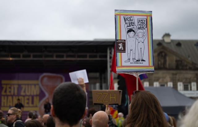 13 September 2026, Saxony, Dresden: A sign reading "FCK AfD - FCK NZS" can be seen at a demonstration on Theaterplatz, under the slogan "Time to Act" in response to the state election in Saxony-Anhalt. Photo: Katharina Kausche/dpa