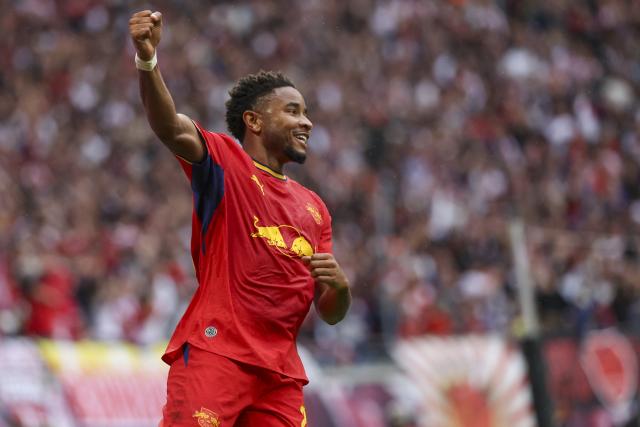 13 September 2026, Saxony, Leipzig: Leipzig's Christopher Nkunku celebrates scoring his side's fourth goal during the German Bundesliga soccer match between RB Leipzig and Hamburger SV at Red Bull Arena. Photo: Jan Woitas/dpa - IMPORTANT NOTICE: In accordance with the regulations of the Bundesliga and the DFB (German Football Association), it is prohibited to use or allow the use of photographs taken in the stadium and/or during the game in the form of sequential images and/or video-like photo sequences.