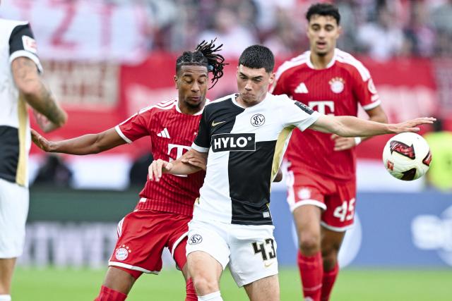 13 September 2026, Saarland, Spiesen-Elversberg: Bayern Munich's Michael Olise (L) and Elversberg's Felix Keidel battle for the ball during the German Bundesliga soccer match between Elversberg and Bayern Munich at Ursapharm-Arena. Photo: Uwe Anspach/dpa - IMPORTANT NOTICE: In accordance with the regulations of the Bundesliga and the DFB (German Football Association), it is prohibited to use or allow the use of photographs taken in the stadium and/or during the game in the form of sequential images and/or video-like photo sequences.