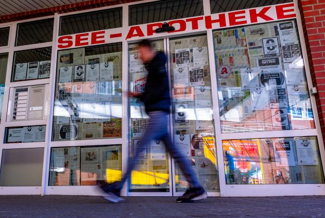 FILED - 23 March 2026, Grevesmühlen: FILE PHOTO - A man walks past the See-Apotheke pharmacy. Photo: Jens Büttner/dpa