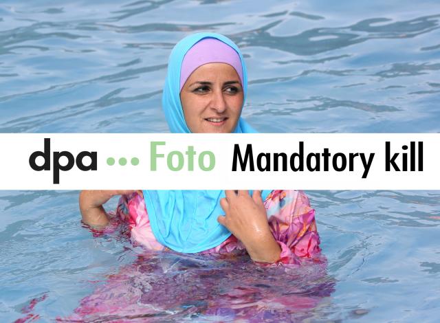 FILED - 20 August 2012, Berlin: Dear customers, for legal reasons, please do not use the image sent on 7 August 2026 and please delete it from your system.

FILE PHOTO - A young Turkish woman cools off while wearing a burkini at an open-air pool in Berlin. Photo: picture alliance / dpa
