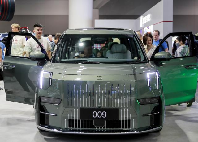 (241108) -- SYDNEY, Nov. 8, 2024 (Xinhua) -- Audience look at Zeekr 009 presented during the Sydney International EV AutoShow 2024 in Sydney, Australia, Nov. 8, 2024. The three-day event kicked off at the International Convention & Exhibition Center in Sydney on Friday, showcasing electric vehicles from global manufacturers. (Xinhua/Ma Ping)