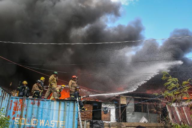 (241124) -- MANILA, Nov. 24, 2024 (Xinhua) -- Firefighters try to put out a fire engulfing a slum area in Manila, the Philippines on Nov. 24, 2024. (Xinhua/Rouelle Umali)