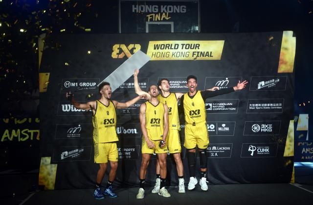 (241124) -- HONG KONG, Nov. 24, 2024 (Xinhua) -- Players of Amsterdam celebrate on the podium after winning the final match between Amsterdam of the the Netherlands and Paris of France at the International Basketball Federation (FIBA) 3x3 World Tour Hong Kong Final 2024 in Hong Kong, south China, Nov. 24, 2024. (Photo by Lo Ping Fai/Xinhua)