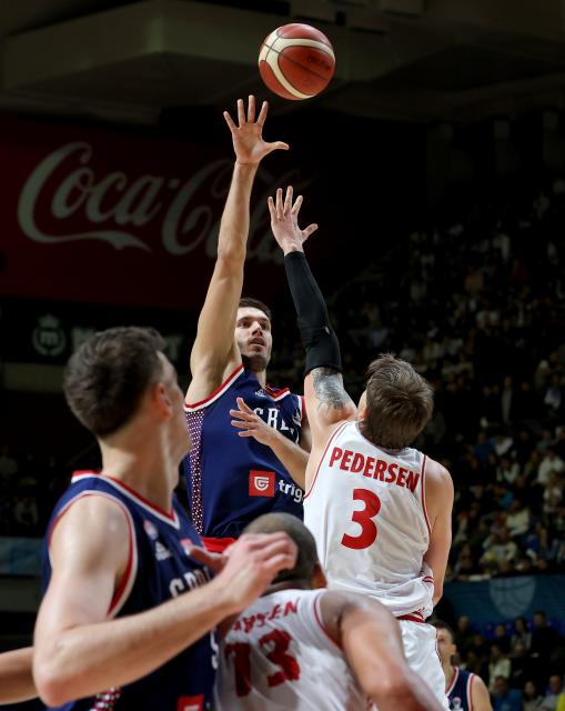 (241125) -- BELGRAD, Nov. 25, 2024 (Xinhua) -- Serbia's Filip Petrusev (top) shoots past Denmark's Sylvester Berg Pedersen during the Group G match between Serbia and Denmark at the FIBA EuroBasket 2025 Qualifiers in Belgrade, Serbia, on Nov. 24, 2024. (Photo by Predrag Milosavljevic/Xinhua)