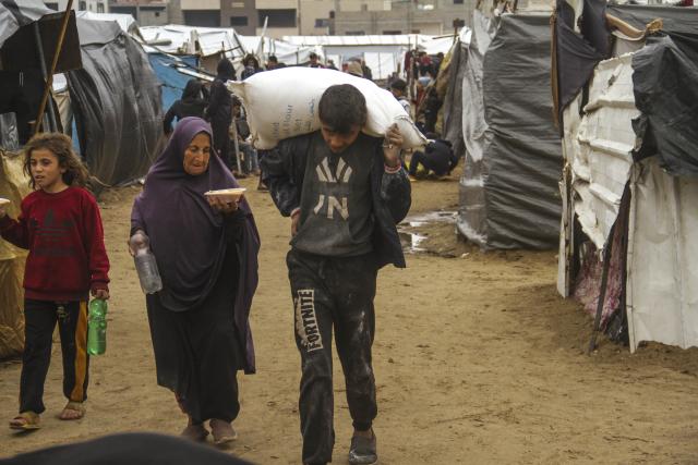 (241125) -- GAZA CITY, Nov. 25, 2024 (Xinhua) -- Palestinians are seen among tents for displaced people in the Al-Yarmouk stadium in Gaza City, on Nov. 24, 2024.
  The Civil Defense in the Gaza Strip warned on Sunday of a "humanitarian disaster" due to rainwater, which could cause flooding and damage to the tents of displaced people. (Photo by Mahmoud Zaki/Xinhua)