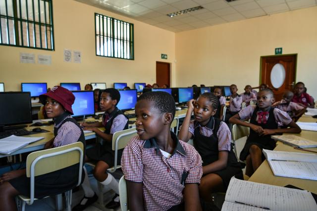 (241126) -- KWENENG, Nov. 26, 2024 (Xinhua) -- Students take a computer class at China-aided Mmopane Primary School in Mmopane, Kweneng District, Botswana, Nov. 4, 2024. Mmopane Primary School, which opened in 2021, is one of the four primary schools in Botswana built with a grant from the Chinese government, the other three being Kubung Primary School, Dinokwane Primary School, and Ramaeba Primary School. These China-aided schools feature computer labs, science labs, libraries, dining halls, disability-friendly facilities, and football and basketball fields. (Xinhua/Han Xu)