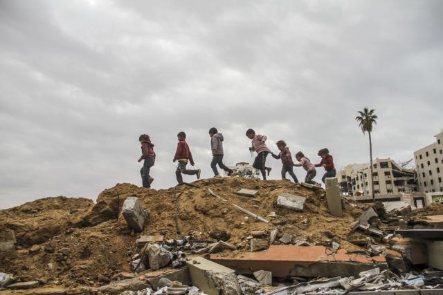 (241130) -- GAZA, Nov. 30, 2024 (Xinhua) -- Palestinian children walk on the rubble in Gaza City, Nov. 28, 2024.
  The United Nations Relief and Works Agency for Palestine Refugees in the Near East (UNRWA) said on Friday that Gaza endured the most intense civilian bombardment in the past year since World War II. (Photo by Mahmoud Zaki/Xinhua)