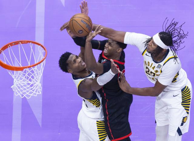 (241204) -- TORONTO, Dec. 4, 2024 (Xinhua) -- RJ Barrett (C) of Toronto Raptors makes a layup as Myles Turner (R) and Bennedict Mathurin of Indiana Pacers defend during the 2024-2025 NBA Cup group game between Toronto Raptors and Indiana Pacers in Toronto, Canada, on Dec. 3, 2024. (Photo by Zou Zheng/Xinhua)