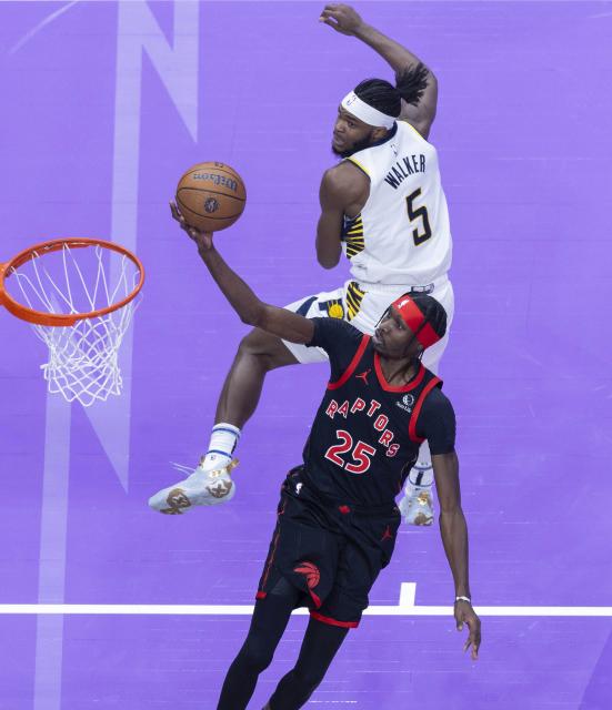 (241204) -- TORONTO, Dec. 4, 2024 (Xinhua) -- Chris Boucher (front) of Toronto Raptors goes up for a layup during the 2024-2025 NBA Cup group game between Toronto Raptors and Indiana Pacers in Toronto, Canada, on Dec. 3, 2024. (Photo by Zou Zheng/Xinhua)