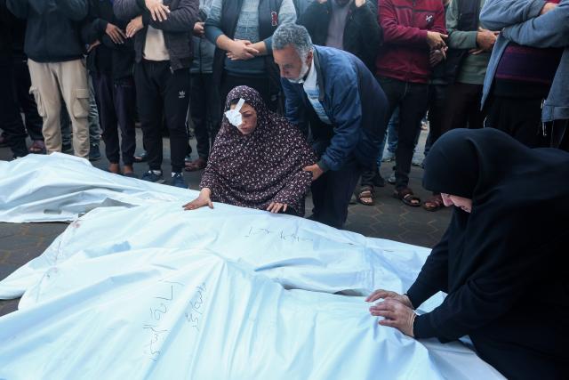 (241212) -- GAZA, Dec. 12, 2024 (Xinhua) -- People mourn over victims killed in an Israeli airstrike at Al-Aqsa Martyrs Hospital in Deir al-Balah, the central Gaza Strip, on Dec. 12, 2024. The Palestinian death toll from ongoing Israeli attacks in Gaza has risen to 44,835, Gaza-based health authorities said in a statement on Thursday. (Photo by Rizek Abdeljawad/Xinhua)