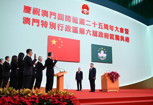 (241220) -- MACAO, Dec. 20, 2024 (Xinhua) -- Chinese President Xi Jinping, also general secretary of the Communist Party of China Central Committee and chairman of the Central Military Commission, administers the oath of office to principal officials of the sixth-term government of the Macao Special Administrative Region (SAR), who are led by Sam Hou Fai, the sixth-term chief executive of the Macao SAR, at the Macao East Asian Games Dome in Macao, south China, Dec. 20, 2024. Xi on Friday delivered a speech at a meeting celebrating the 25th anniversary of Macao's return to the motherland and the inaugural ceremony of the sixth-term government of the Macao SAR. (Xinhua/Xie Huanchi)