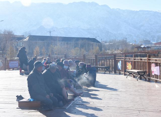 (241221) -- WENQUAN, Dec. 21, 2024 (Xinhua) -- People soak their feet in the soothing warmth of a natural hot spring in Wenquan County, northwest China's Xinjiang Uygur Autonomous Region, Nov. 28, 2024. TO GO WITH "Wondrous Xinjiang: Hot springs spread warmth among locals, tourists" (Xinhua/Zhang Xiaolong)