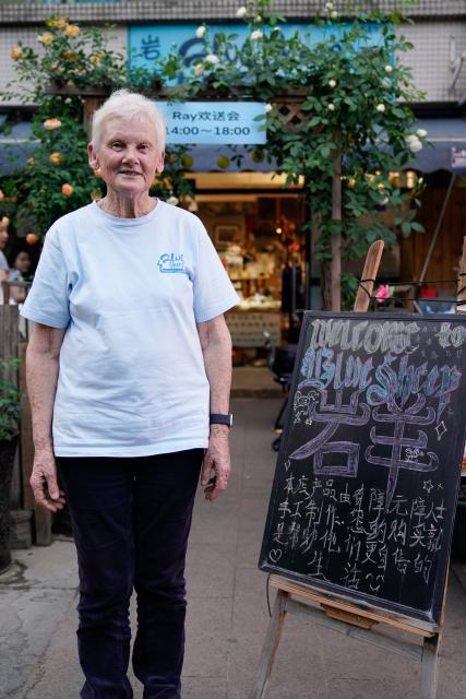 (250509) -- CHENGDU, May 9, 2025 (Xinhua) -- Rachel Grace Pinniger poses for a photo in front of the handicrafts shop Blue Sheep in Chengdu, southwest China's Sichuan Province, April 19, 2025.
  All eyes were on the beloved Rachel Grace Pinniger, nicknamed "Grandma Rachel," at a farewell event held in front of Blue Sheep in April. 
  Rachel, 79, a native to England, has traversed conflict zones and disaster-hit areas after graduation from medical school to pursue a career of medical, healthcare and education services in more than a dozen of developing countries across Asia and Africa.
  Rachel rushed to Sichuan in 2008, and devoted herself wholeheartedly to the Wenchuan earthquake relief efforts, and kept thinking how she could help more. In 2013, Rachel moved to Chengdu and founded the handicrafts shop Blue Sheep, named after the Himalayan mountain goats that thrive in the plateau's harsh natural environment. 
   The shop deals handicrafts made by disabled artisans and struggling families. Over the past decade, the shop has supported more than 1,000 disadvantaged individuals in Sichuan.
  Before her 80th birthday, Rachel decided to leave Chengdu and return to her hometown with precious memories. At the farewell event held by Blue Sheep's staff and volunteers, she said she would continue to care for those in need, and encourage the loving ones to keep their support for Blue Sheep and the artisans who craft hope with their deft fingers and steadfast minds. (Xinhua/Xu Bingjie)