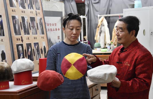 (250510) -- BEIJING, May 10, 2025 (Xinhua) -- Li Jinshan (R), an inheritor of Shengxifu hat making technique, talks with a young technician on hat designs at a Shengxifu workshop in Beijing, capital of China, April 22, 2025.
  Shengxifu, one of Beijing's time-honored brands, was established in 1911 and remains popular among people owing to its outstanding skills and premium quality. Its hat making technique was listed as a national intangible cultural heritage in 2008.
  Hat making of Shengxifu requires painstaking efforts, ranging from hide picking and material matching, to fur tailoring and leather flattening. Each procedure is demanding and must be done by hand.
  To better balance ancient craftsmanship and modern creativity, the brand continues imbibing new technologies, equipment and designs, keeping the traditional workmanship running along with the fashion. (Xinhua/Li Xin)