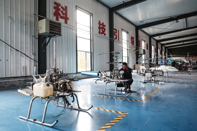 (250510) -- SHENYANG, May 10, 2025 (Xinhua) -- An engineer assembles an unmanned helicopter at a workshop of FaKu Zhong Jun Yi UAV Technology Co., Ltd. in Faku County, in Shenyang, northeast China's Liaoning Province, April 25, 2025.
  As an important driving force of new economic momentum, the low-altitude economy is viewed by many as a key strategic emerging industry.
   In recent years, Liaoning Province has seized opportunities to actively develop its low-altitude economy. Taking full advantage of its location and its strengths in the fields of aviation and aerospace, the province has focused its development of the low-altitude economy on the general aviation and drone sectors, and enriched application scenarios such as emergency rescue, sightseeing tourism, and agricultural and forestry protection.
   A development pattern featuring Shenyang and Dalian as key forces supporting Liaoning's low-altitude economy is taking shape, ranging from China's home-grown four-seat electric aircraft RX4E, independently developed by the Liaoning General Aviation Academy of Shenyang Aerospace University, securing the first type certificate, to a drone powered by an ultra-low-temperature high-energy-density lithium battery, developed by the Dalian Institute of Chemical Physics under the Chinese Academy of Sciences, completing a flight test under extreme cold conditions. 
   The Shenyang general aviation industry base has attracted a cluster of enterprises, and multiple low-altitude passenger routes have been launched in Dalian. The low-altitude economy has injected impetus into the high-quality development of Liaoning Province. (Xinhua/Pan Yulong)