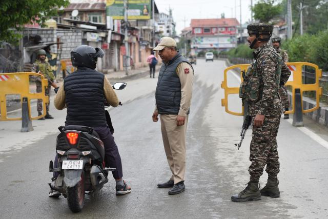 (250510) -- SRINAGAR, May 10, 2025 (Xinhua) -- An Indian paramilitary trooper stops a man on scooter at a checkpoint as security beefed up in Srinagar city, the summer capital of Indian-controlled Kashmir, May 10, 2025. (Xinhua/Javed Dar)