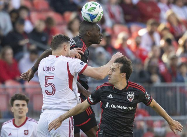 (250511) -- TORONTO, May 11, 2025 (Xinhua) -- Christian Benteke (Top C) of D.C. United vies for a header with Kevin Long (Top L) of Toronto FC during the 2025 Major League Soccer (MLS) regular season match between Toronto FC and D.C. United at BMO Field in Toronto, Canada, May 10, 2025. (Photo by Zou Zheng/Xinhua)