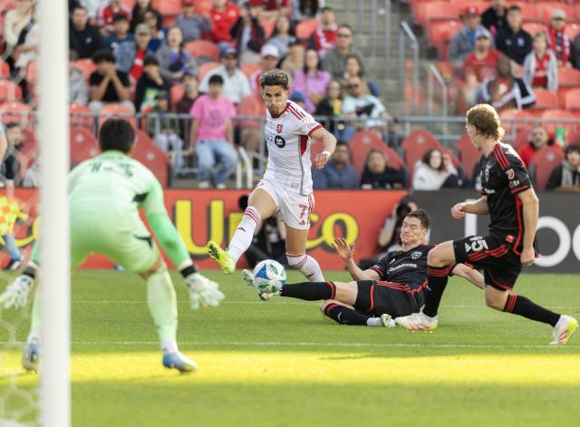 (250511) -- TORONTO, May 11, 2025 (Xinhua) -- Theo Corbeanu (2nd L) of Toronto FC passes the ball during the 2025 Major League Soccer (MLS) regular season match between Toronto FC and D.C. United at BMO Field in Toronto, Canada, May 10, 2025. (Photo by Zou Zheng/Xinhua)