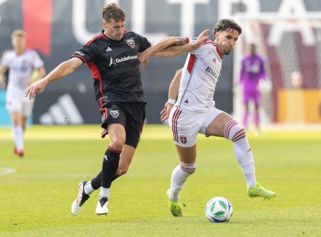 (250511) -- TORONTO, May 11, 2025 (Xinhua) -- Theo Corbeanu (R) of Toronto FC vies with Lucas Bartlett of D.C. United during the 2025 Major League Soccer (MLS) regular season match between Toronto FC and D.C. United at BMO Field in Toronto, Canada, May 10, 2025. (Photo by Zou Zheng/Xinhua)