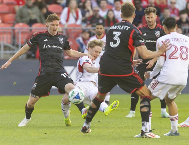 (250511) -- TORONTO, May 11, 2025 (Xinhua) -- Ola Brynhilden (2nd L) of Toronto FC shoots the ball during the 2025 Major League Soccer (MLS) regular season match between Toronto FC and D.C. United at BMO Field in Toronto, Canada, May 10, 2025. (Photo by Zou Zheng/Xinhua)