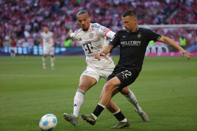(250511) -- MUNICH, May 11, 2025 (Xinhua) -- Bayern Munich's Leroy Sane (L) vies with Moenchengladbach's Stefan Lainer during the German first division Bundesliga football match between Bayern Munich and Borussia Moenchengladbach in Munich, Germany, May 10, 2025. (Photo by Philippe Ruiz/Xinhua)