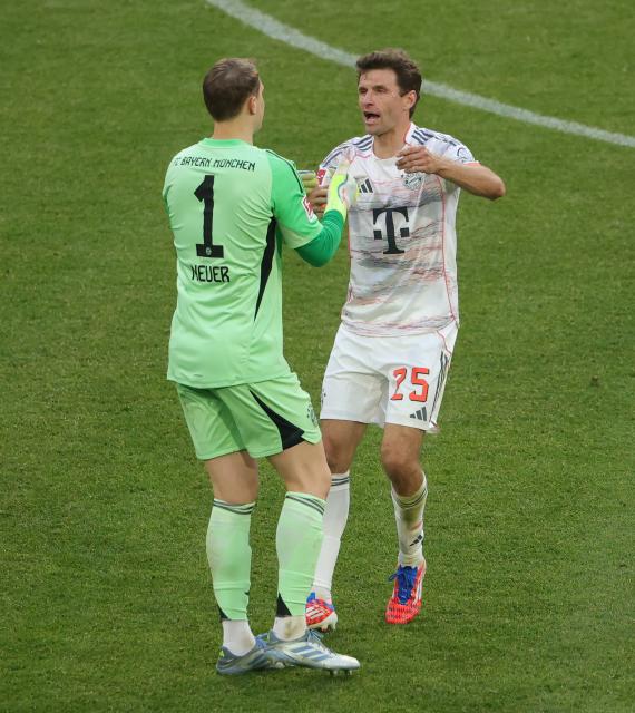(250511) -- MUNICH, May 11, 2025 (Xinhua) -- Bayern Munich's Thomas Mueller (R) gestures to his teammate Manuel Neuer before being substituted during the German first division Bundesliga football match between Bayern Munich and Borussia Moenchengladbach in Munich, Germany, May 10, 2025. (Photo by Philippe Ruiz/Xinhua)
