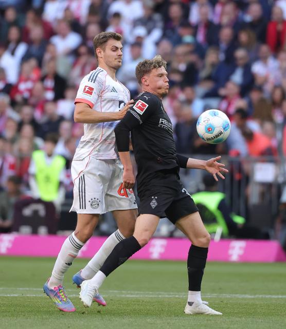 (250511) -- MUNICH, May 11, 2025 (Xinhua) -- Bayern Munich's Josip Stanisic (L) vies with Moenchengladbach's Robin Hack during the German first division Bundesliga football match between Bayern Munich and Borussia Moenchengladbach in Munich, Germany, May 10, 2025. (Photo by Philippe Ruiz/Xinhua)