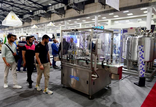 (250511) -- DAMASCUS, May 11, 2025 (Xinhua) -- Attendees observe a machine on display at the Techno Build exhibition, in Damascus, Syria, on May 10, 2025. The fair, showcasing a wide range of services and solutions for building, construction and infrastructure, drew more than 500 local and international companies. (Photo by Ammar Safarjalani/Xinhua)