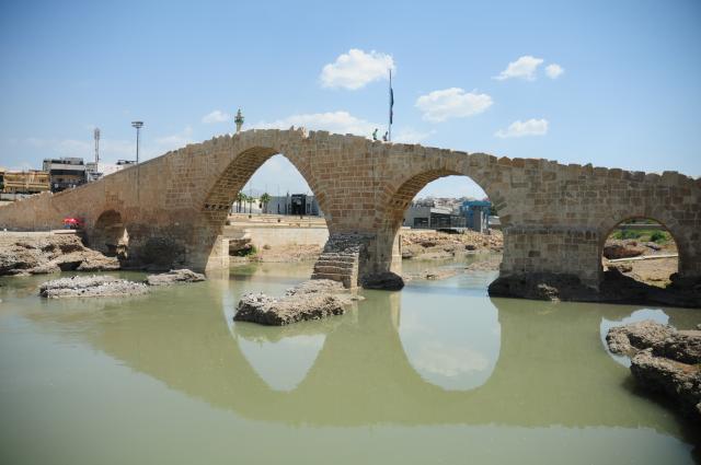 (250511) -- DOHUK, May 11, 2025 (Xinhua) -- People walk on the ancient Dalal Bridge in Dohuk province, Iraq, May 10, 2025. The construction of Dalal Bridge dates back to the period of the Byzantine Empire. (Xinhua/Duan Minfu)