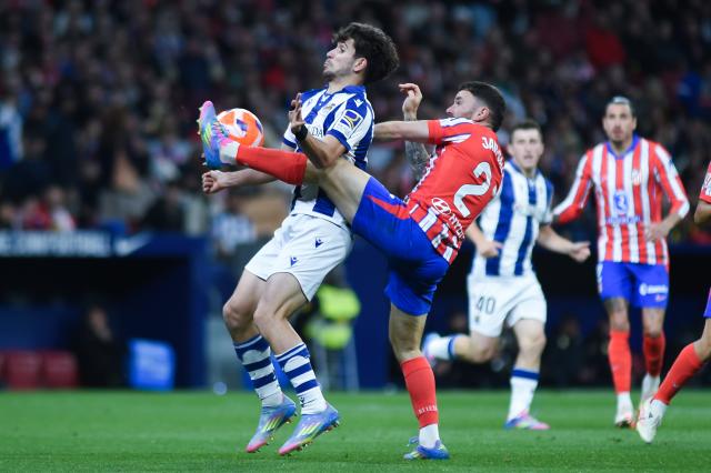 (250511) -- MADRID, May 11, 2025 (Xinhua) -- Javi Galan (R) of Atletico de Madrid vies with Pablo Marin of Real Sociedad during the LaLiga football match between Atletico de Madrid and Real Sociedad in Madrid, Spain, on May 10, 2025. (Photo by Gustavo Valiente/Xinhua)