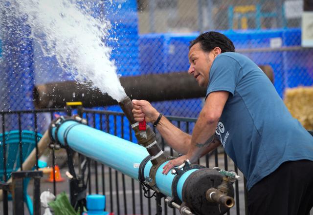 (250511) -- RICHMOND, May 11, 2025 (Xinhua) -- A worker demonstrates water pipe operations during the Public Works Open House event in Richmond, British Columbia, Canada, May 10, 2025. Featuring interactive exhibits, equipment displays and more, the one-day event offered a behind-the-scenes look at the essential services that keep the city running smoothly. (Photo by Liang Sen/Xinhua)
