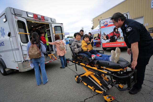 (250511) -- RICHMOND, May 11, 2025 (Xinhua) -- People experience ambulance equipment at the Public Works Open House event in Richmond, British Columbia, Canada, May 10, 2025. Featuring interactive exhibits, equipment displays and more, the one-day event offered a behind-the-scenes look at the essential services that keep the city running smoothly. (Photo by Liang Sen/Xinhua)