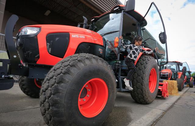(250511) -- RICHMOND, May 11, 2025 (Xinhua) -- A girl explores a tractor during the Public Works Open House event in Richmond, British Columbia, Canada, May 10, 2025. Featuring interactive exhibits, equipment displays and more, the one-day event offered a behind-the-scenes look at the essential services that keep the city running smoothly. (Photo by Liang Sen/Xinhua)