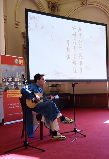 (250511) -- GRAZ, May 11, 2025 (Xinhua) -- A contestant sings during the 24th "Chinese Bridge" Chinese Proficiency Competition for College Students in Graz, Austria, May 10, 2025. The Austrian division finals of the 24th "Chinese Bridge" Chinese Proficiency Competition for College Students was held on Saturday in Graz. (Xinhua/He Canling)