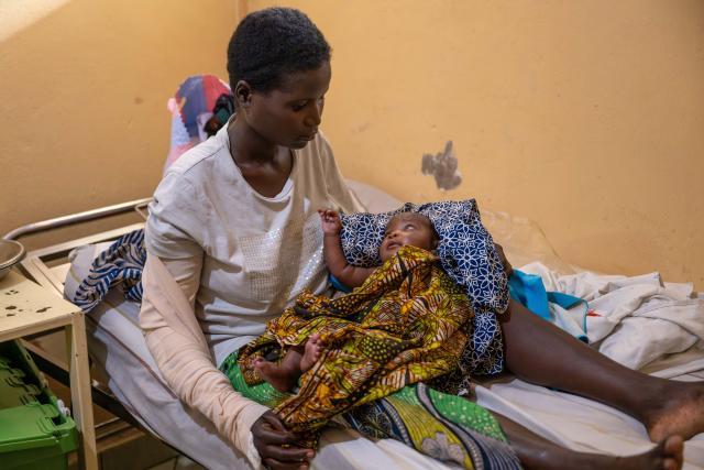 (250511) -- GOMA, May 11, 2025 (Xinhua) -- An injured mother takes care of her baby at Ndosho Hospital in Goma, the Democratic Republic of the Congo (DRC), on May 10, 2025. Ndosho Hospital, located in Goma, the capital city of North Kivu province in the eastern DRC, has built temporary tents in its parking lot to relieve pressure and increased its bed capacity to approximately 130, as the security situation in the eastern DRC has deteriorated in recent years. (Xinhua/Zheng Yangzi)