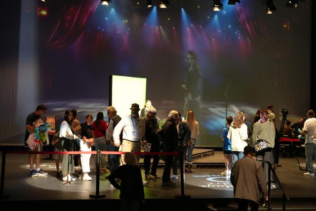 (250511) -- CANBERRA, May 11, 2025 (Xinhua) -- Visitors interact on stage, experiencing theatrical lighting effects from a performer's perspective, during an open day event of the Canberra Theater Center in Canberra, Australia, on May 10, 2025. The Canberra Theater Center opened its doors to the public on Saturday as part of its 60th anniversary celebrations. (Photo by Zhang Na/Xinhua)