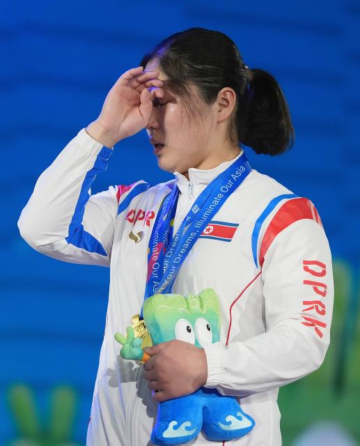 (250511) -- JIANGSHAN, May 11, 2025 (Xinhua) -- Total gold medalist Kim Il Gyong of the Democratic People's Republic of Korea (DPRK) reacts during the awarding ceremony for the women's 59kg competition at 2025 Asian Weightlifting Championships in Jiangshan, east China's Zhejiang Province, May 11, 2025. (Xinhua/Hou Zhaokang)