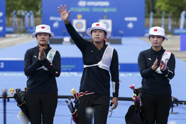 (250511) -- SHANGHAI, May 11, 2025 (Xinhua) -- Zhu Jingyi (C) of China greets the audience with Huang Yuwei (L) and Li Jiaman before the gold final of the Recurve Women's Team competition at Shanghai 2025 Archery World Cup Stage 2 in Shanghai, east China, May 11, 2025. (Xinhua/Wang Xiang)