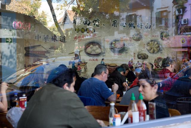 (250511) -- BUENOS AIRES, May 11, 2025 (Xinhua) -- People enjoy food at a restaurant in the Chinatown in Buenos Aires, Argentina, May 10, 2025. In 2009, the archway of the Chinatown in Buenos Aires was officially completed. Nowadays, the Chinatown has become an important tourist attraction in the local area, attracting many people to experience the charm of Eastern culture. (Xinhua/Meng Dingbo)