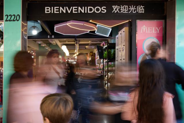 (250511) -- BUENOS AIRES, May 11, 2025 (Xinhua) -- People walk past a Chinese supermarket in the Chinatown in Buenos Aires, Argentina, May 10, 2025. In 2009, the archway of the Chinatown in Buenos Aires was officially completed. Nowadays, the Chinatown has become an important tourist attraction in the local area, attracting many people to experience the charm of Eastern culture. (Xinhua/Meng Dingbo)