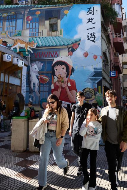 (250511) -- BUENOS AIRES, May 11, 2025 (Xinhua) -- People walk near the Chinatown in Buenos Aires, Argentina, May 10, 2025. In 2009, the archway of the Chinatown in Buenos Aires was officially completed. Nowadays, the Chinatown has become an important tourist attraction in the local area, attracting many people to experience the charm of Eastern culture. (Xinhua/Meng Dingbo)