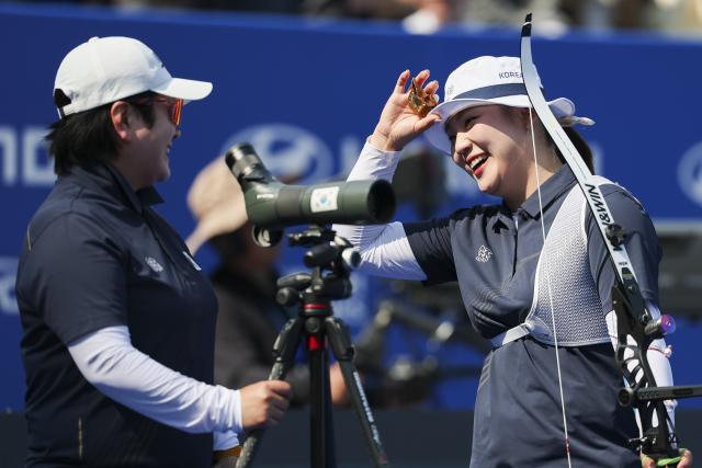 (250511) -- SHANGHAI, May 11, 2025 (Xinhua) -- Lee Gahyun (R) of South Korea communicates with her coach during the gold final of the Recurve Women's competition at Shanghai 2025 Archery World Cup Stage 2 in Shanghai, east China, May 11, 2025. (Xinhua/Wang Xiang)