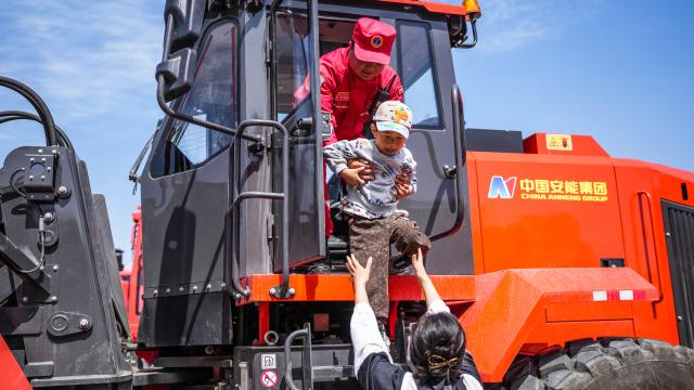 (250511) -- BEIJING, May 11, 2025 (Xinhua) -- A kid tries out a special engineering vehicle during an activity on disaster prevention and reduction held in Guiyang, southwest China's Guizhou Province, May 11, 2025. China observes the National Disaster Prevention and Reduction Day on May 12 each year. Various publicity, drill and training activities are carried out across China to improve public awareness in scientific disaster prevention and self-rescue. (Xinhua/Tao Liang)