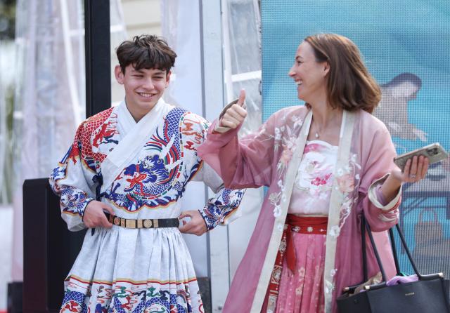(250511) -- AUCKLAND, May 11, 2025 (Xinhua) -- People try traditional Chinese attire during the "Tea for Harmony" cultural salon in Auckland, New Zealand, May 11, 2025. The cultural salon on tea was held on Sunday at the picturesque Howick Historical Village in New Zealand's largest city Auckland, inviting guests and local residents to immerse themselves in the richness of traditional Chinese culture while promoting dialogue and friendship between China and New Zealand. (Xinhua/Long Lei)