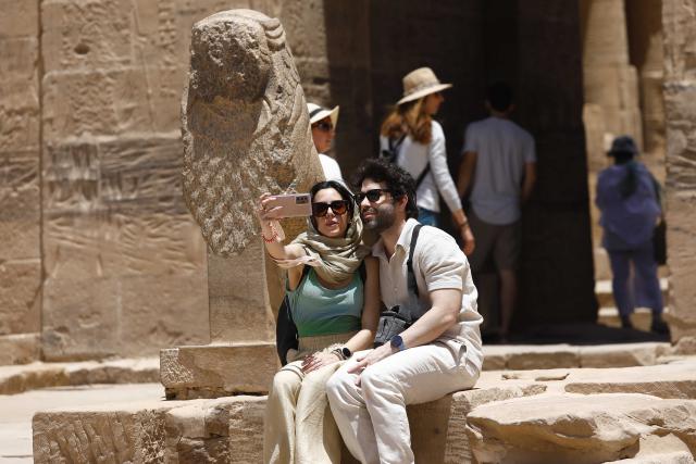 (250512) -- CAIRO, May 12, 2025 (Xinhua) -- Tourists take selfies at the Philae Temple complex by the Nile River in Aswan, Egypt, May 3, 2025.
  TO GO WITH "Feature: Egypt's cultural south charms tourists worldwide" (Xinhua/Ahmed Gomaa)